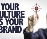 Business man pointing the text: Your Culture is Your Brand