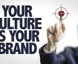 Business man pointing the text: Your Culture is Your Brand